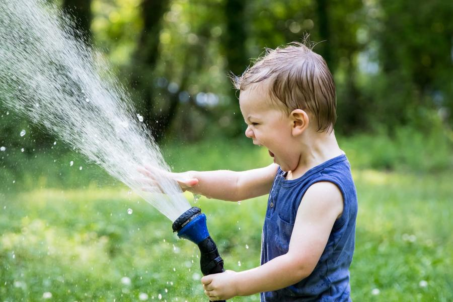 kid playing with hose